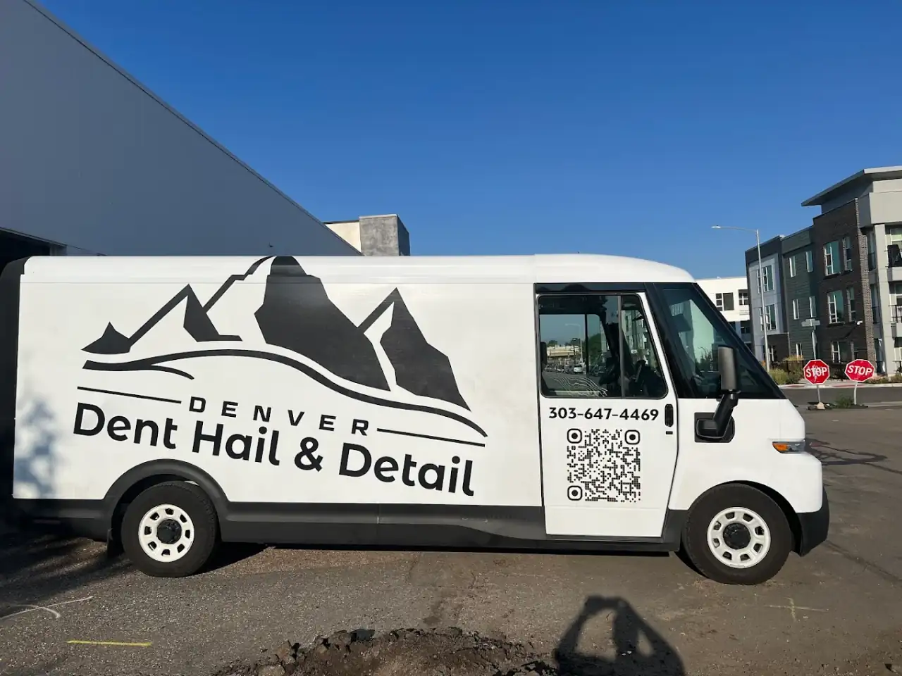 Dent, Hail & Detail branded mobile detailing van at a customer's location in Denver